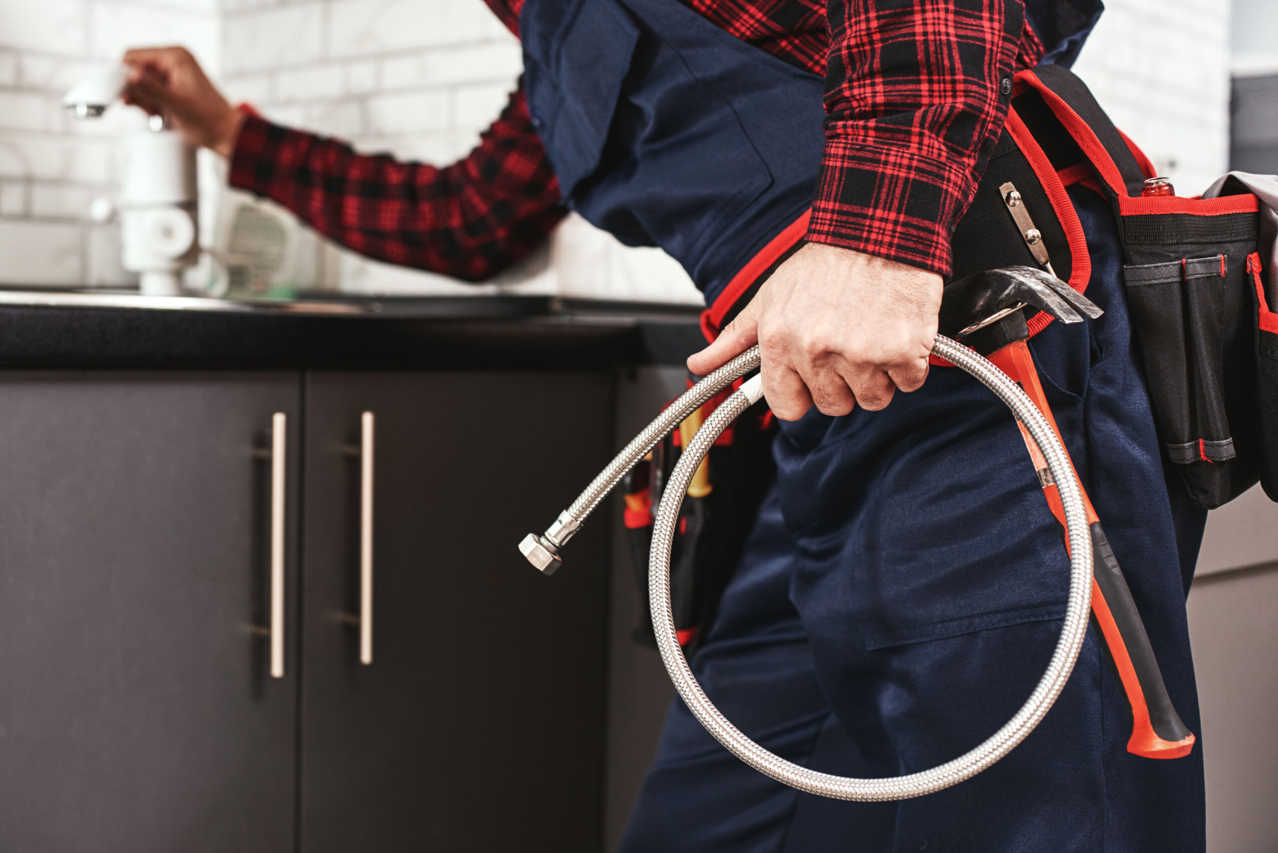 New plumbing. Close-up of foreman checking all things in kitchen sink before push faucet. Cropped photo